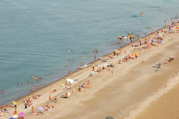 Beach with many people during summer period