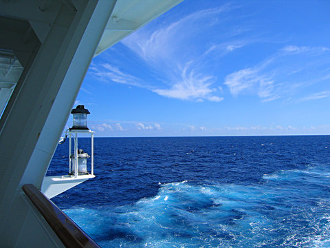 A view of a lantern and an open sea from  the deck