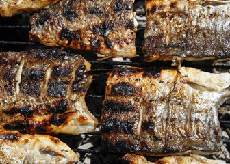 barbecue with delicious roasted  fish on grill