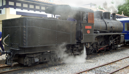 Fototapeta na wymiar Antique train parked in a station