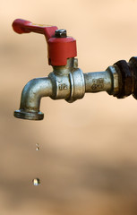 Image shows a tap dripping water against a dry background - 3901832
