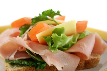 Ham lettuce tomato and cheese open sandwich on wholemeal bread.