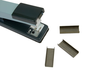 Office stapler and clips, close-up, isolated on white background