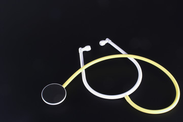 A medical stethoscope on a dark background.