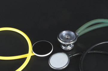 A colection of different styles of medical stethoscopes.