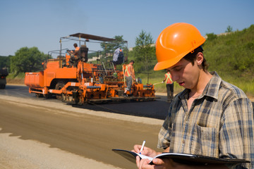 The road inspector. Stacking of new asphalt.