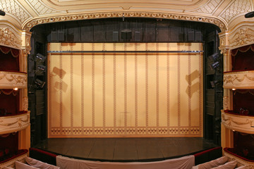 Theater stage with gold safety curtains