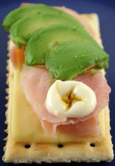 Ham, cheese and avocado crackers with hot english mayo.