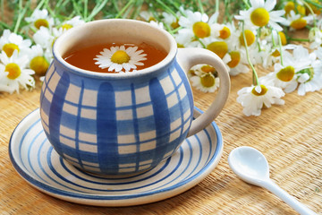 Cup of herbal tea - chamomile and flowers