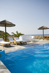 swimming pool by sea at resort hotel luxurious greek island