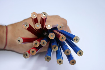 In a hand dark blue and red pencils