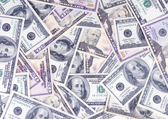 A pile of fifty and hundred dollar bills. Saving for college