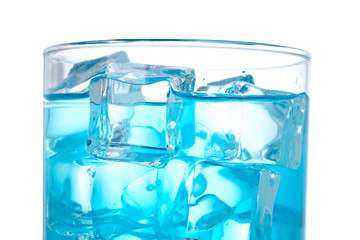 Blue cocktail with ice cubes on white background. Shallow DOF