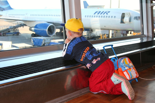 Small boy looking at airplanes. Airoport of Helsinki.