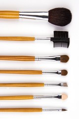 Cosmetic brushes lined up in white background.