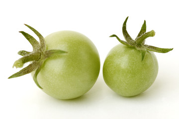 Green tomatoes on white