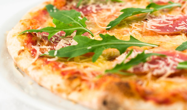 Pzza with sausages and salad