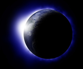 Rising sun behind planet earth
