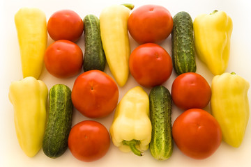 tomatoes, peppers and cucumbers over white background