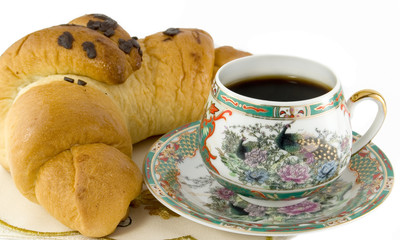 The cup coffee and croissant on white background.