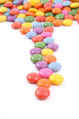 row of colorful candies isolated on white