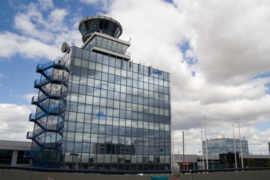 Airport control tower over cloudy blue sky
