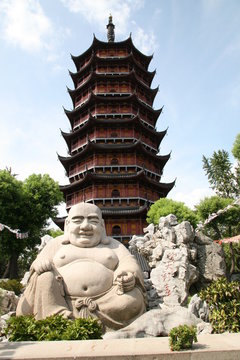 Smiling buddha statue before pagoda in Suzhou China
