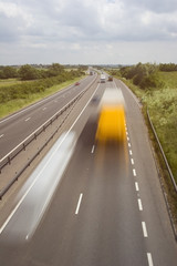 Blurred trucks speeding along a British highway