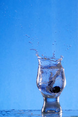 A glass with a drink splashing about