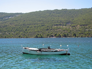 Fototapeta na wymiar old boat and dalmatia landscape