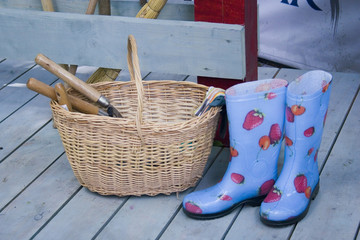 Basket, gum-boots and garden equipment