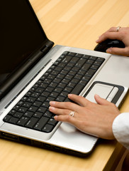 Woman working on laptop.