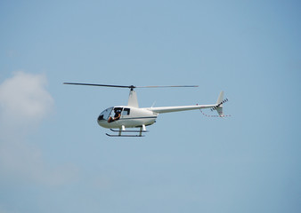 Light sightseeing helicopter in flight - obrazy, fototapety, plakaty