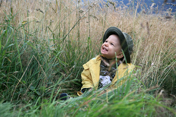 Baby boy playing in the mountain plains