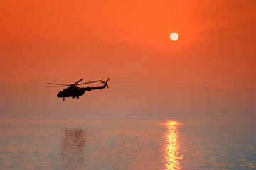 Naklejka na ściany i meble Helikopter na zachodzie słońca