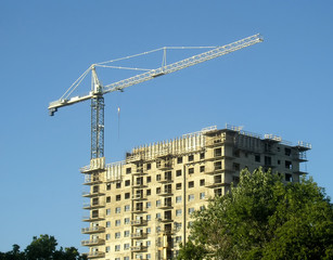 Fototapeta na wymiar Crane and concrete building.