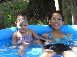 kids swimming in inflatable mini pool