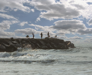 Fishermen on rock pier