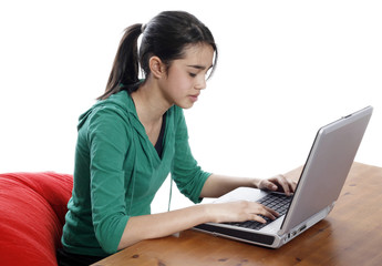 Young pretty women on red bean bag relaxing and using laptop