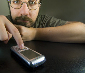 man waiting for a call while the mobile is in the table