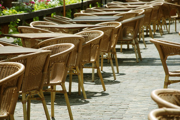 Tables and chairs at street cafe