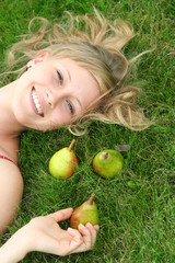 Woman lying on grass, smiling