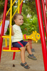 little boy on swings