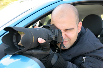 Professional photographer in action with telephoto lens