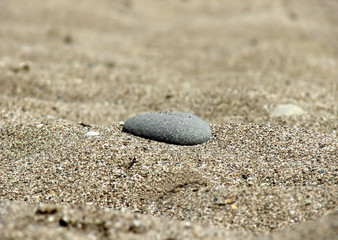 Fototapeta na wymiar stone in the sand