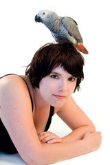 grey parrot on womans head