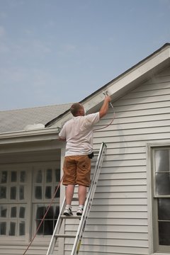 Contractor spraying house