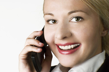 Businesswoman working in office using mobile phone.