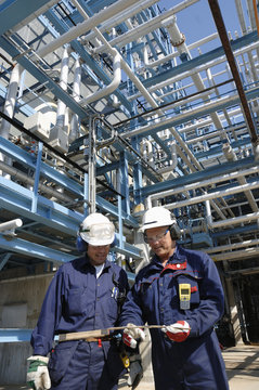 engineers inside oil refinery