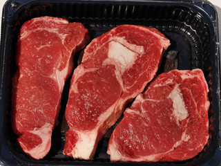 Steakes in plastic container